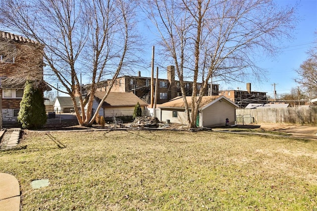 exterior space with an outbuilding, a yard, and fence