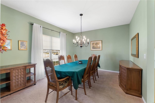 dining space with baseboards, a notable chandelier, and light colored carpet