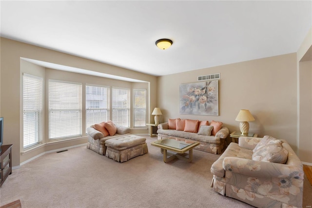 living room featuring carpet floors, visible vents, and baseboards