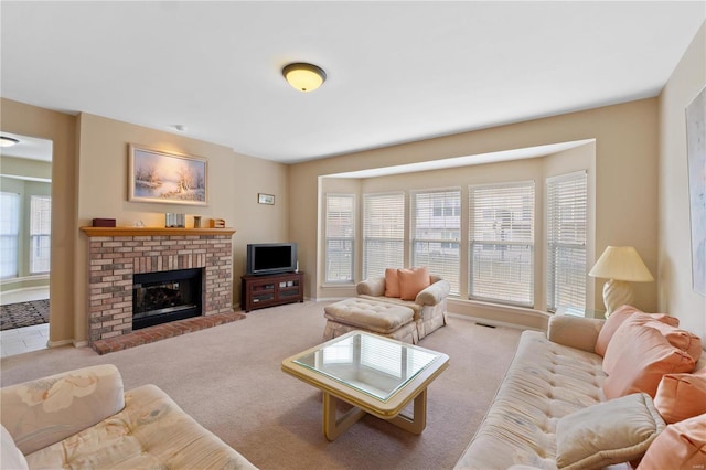 carpeted living room with a fireplace and visible vents