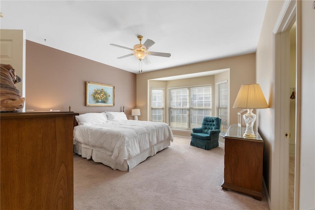 bedroom featuring ceiling fan and light colored carpet