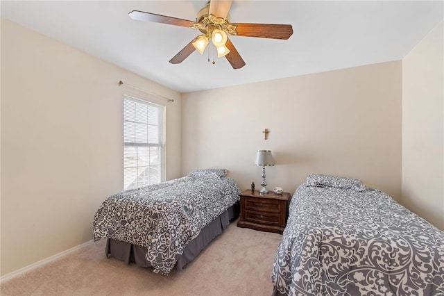 bedroom featuring a ceiling fan, light colored carpet, and baseboards