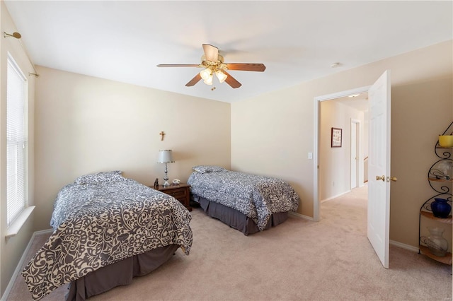 carpeted bedroom featuring baseboards and a ceiling fan