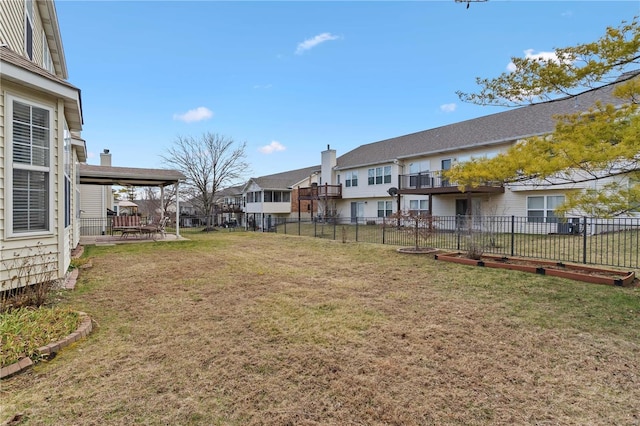 view of yard featuring a patio area, a residential view, and fence