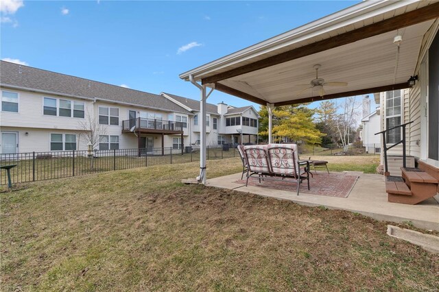 view of yard featuring entry steps, a ceiling fan, a patio, a residential view, and fence