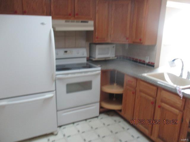 kitchen with sink and white appliances