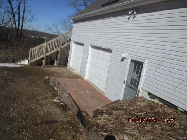 view of side of home with a garage