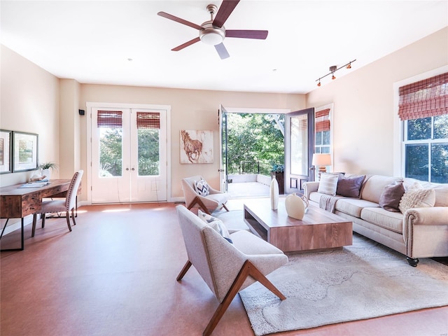 living room featuring rail lighting, french doors, and ceiling fan