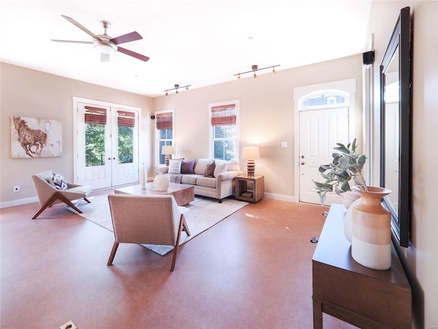 living room featuring track lighting, light colored carpet, ceiling fan, and french doors