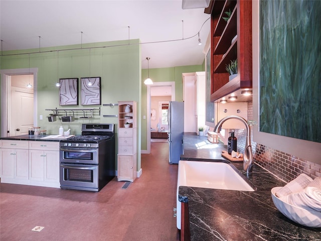 kitchen featuring sink, white cabinetry, decorative light fixtures, stainless steel appliances, and backsplash