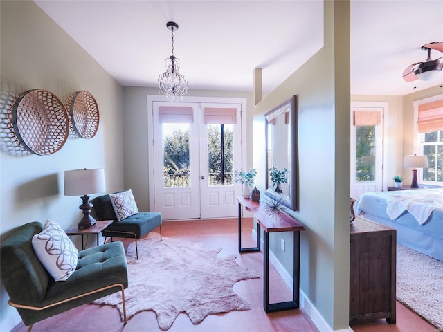 sitting room featuring plenty of natural light and a chandelier