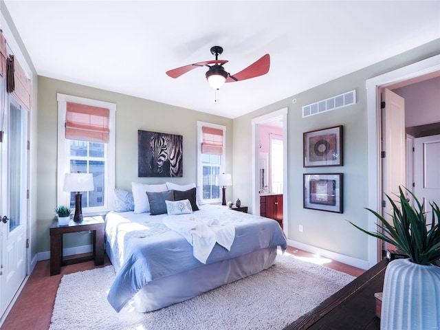 bedroom with ceiling fan and connected bathroom