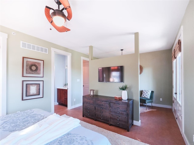 carpeted bedroom featuring ceiling fan and ensuite bath