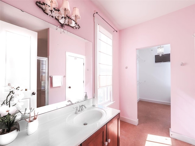 bathroom featuring walk in shower and vanity