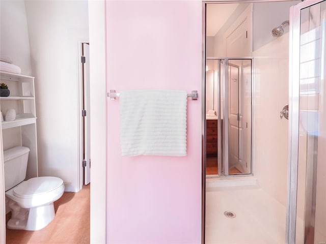 bathroom with an enclosed shower and toilet