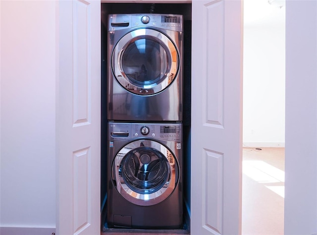 clothes washing area featuring stacked washer and dryer