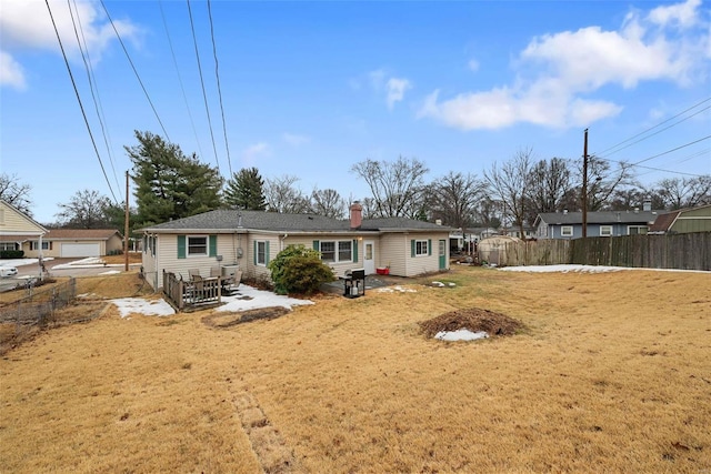 rear view of house featuring a lawn and a patio