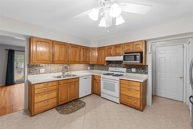 kitchen featuring tasteful backsplash, sink, white appliances, and ceiling fan