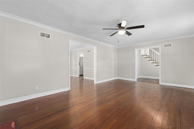 spare room featuring dark wood-type flooring, ceiling fan, and crown molding