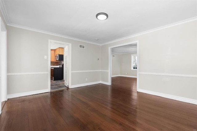 spare room with dark wood-type flooring and ornamental molding