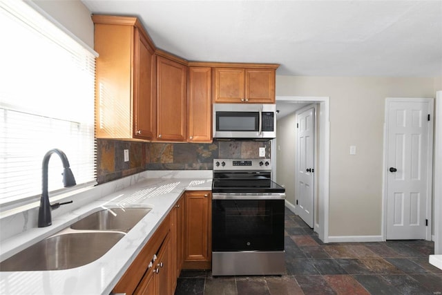 kitchen with tasteful backsplash, stainless steel appliances, and sink