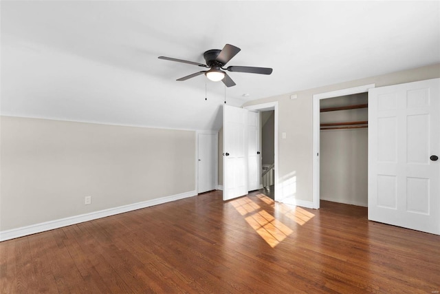 unfurnished bedroom with dark wood-type flooring, ceiling fan, and lofted ceiling