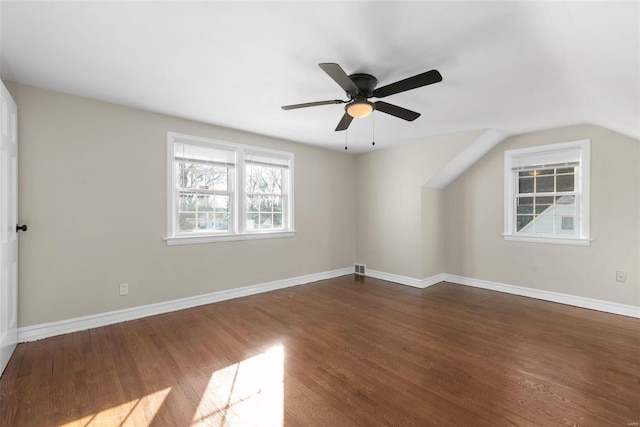 empty room with lofted ceiling, dark wood-type flooring, and ceiling fan