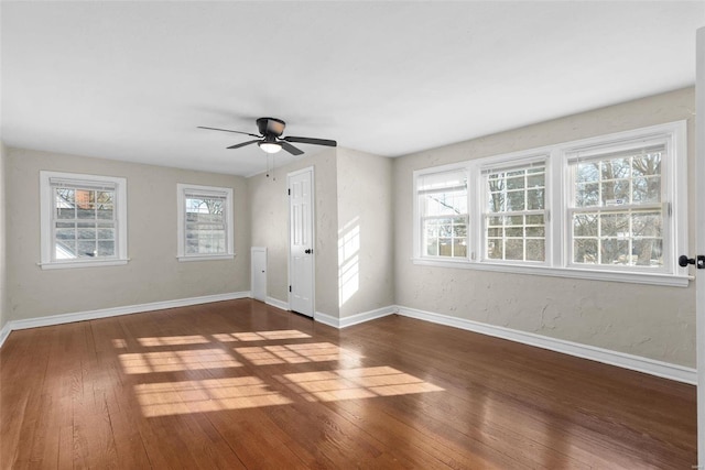 interior space with a healthy amount of sunlight, dark wood-type flooring, and ceiling fan