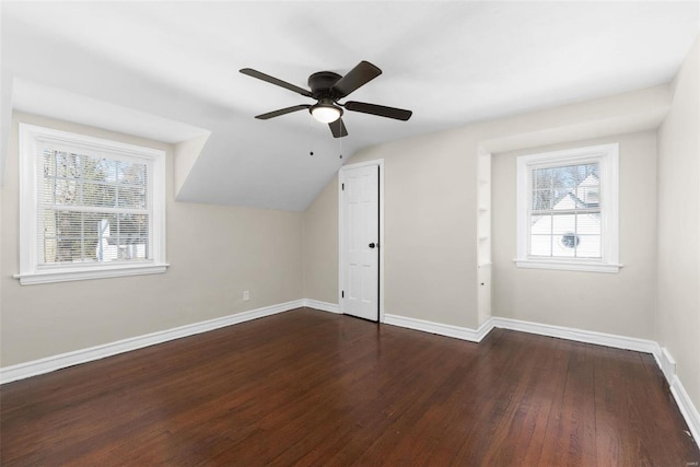 additional living space with ceiling fan, dark hardwood / wood-style floors, and vaulted ceiling