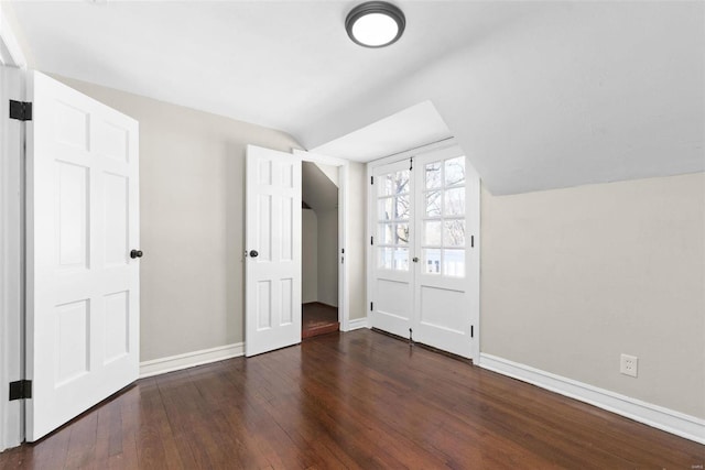 additional living space with dark hardwood / wood-style floors and vaulted ceiling