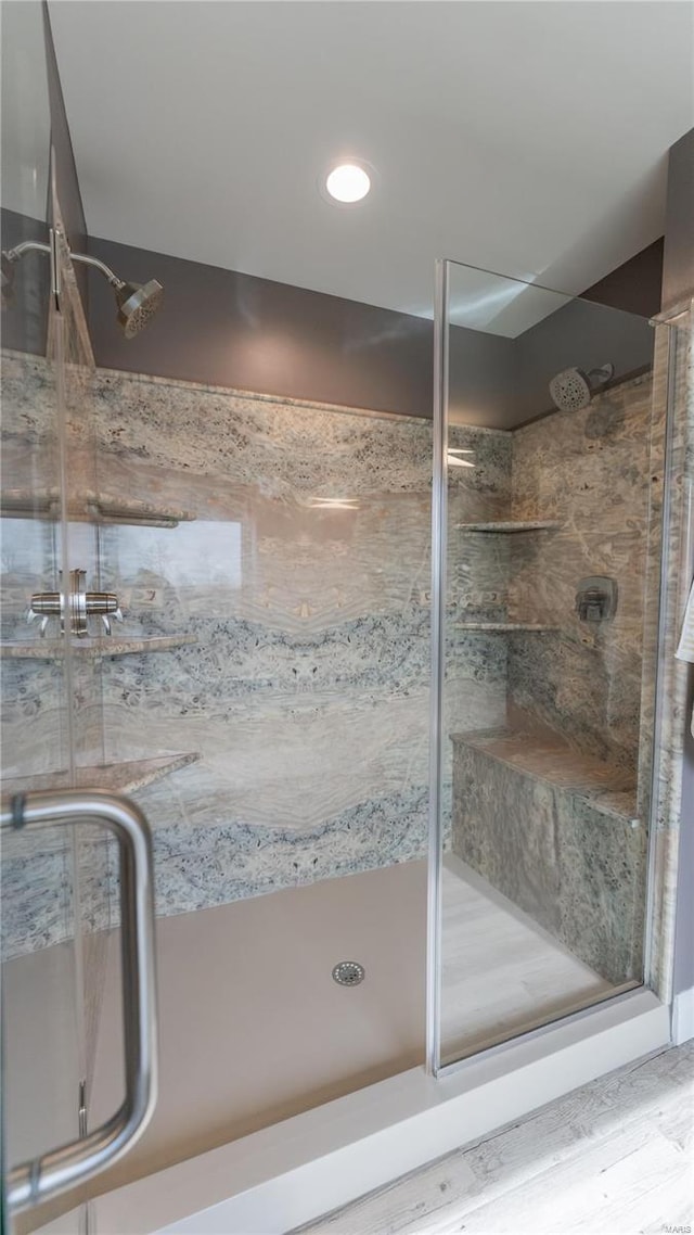 full bathroom with a stall shower and wood finished floors
