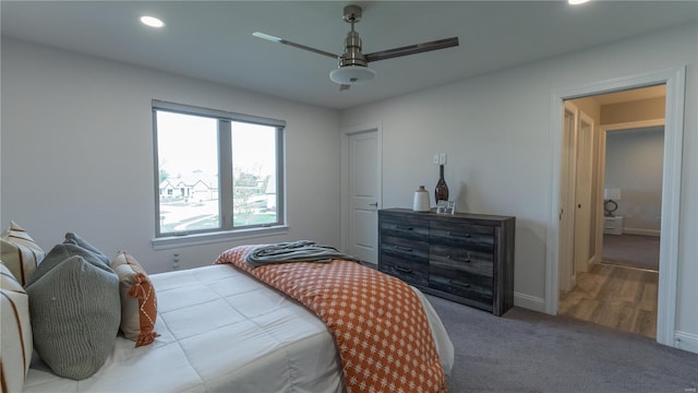 carpeted bedroom featuring baseboards, ceiling fan, and recessed lighting