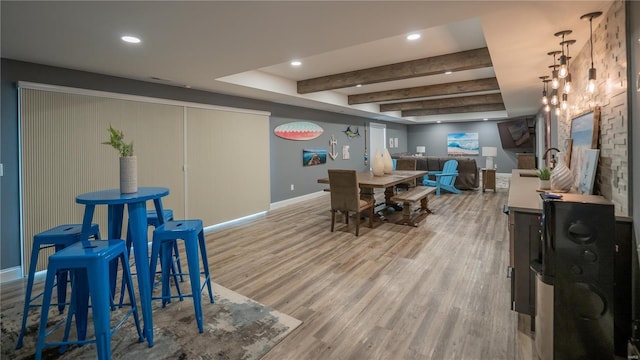 dining space featuring baseboards, recessed lighting, wood finished floors, and beam ceiling