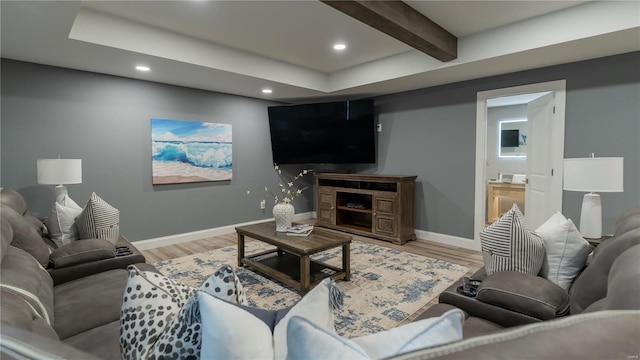 living room featuring recessed lighting, baseboards, beamed ceiling, and light wood-type flooring