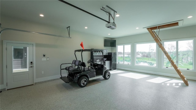 garage with freestanding refrigerator, recessed lighting, and a garage door opener