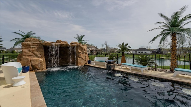 view of pool featuring a water view, fence, and a fenced in pool