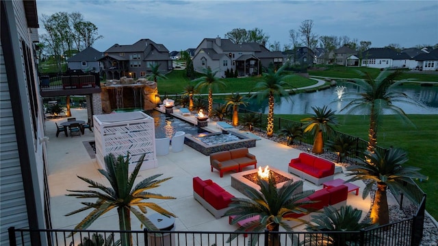 view of patio / terrace featuring a residential view, an outdoor living space with a fire pit, and a fenced backyard