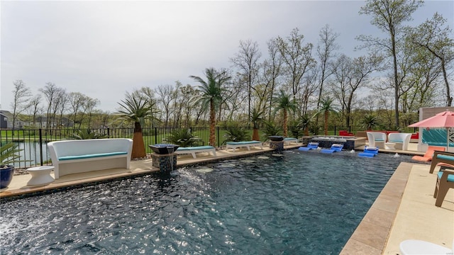 view of swimming pool featuring a swimming pool, fence, and a patio area