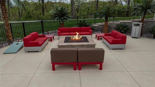 view of patio / terrace with a fenced backyard and an outdoor living space with a fire pit