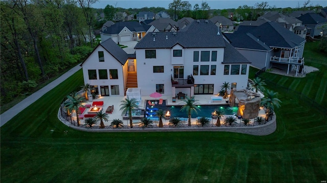 back of property with an outdoor hangout area, a yard, stairway, and a residential view