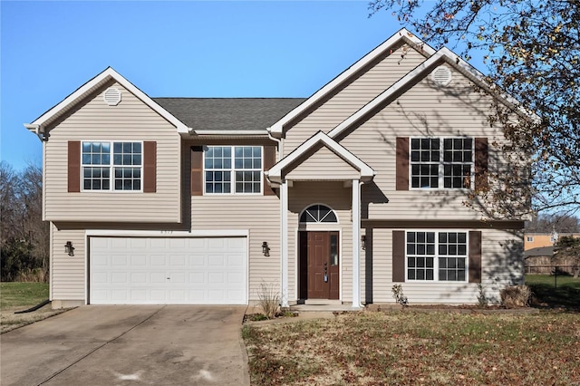 split foyer home featuring a garage and concrete driveway