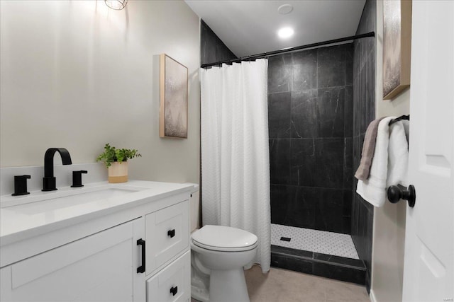 full bath with tiled shower, tile patterned flooring, vanity, and toilet