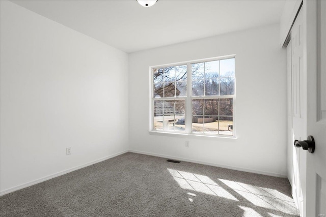 unfurnished bedroom featuring a closet, carpet flooring, visible vents, and baseboards