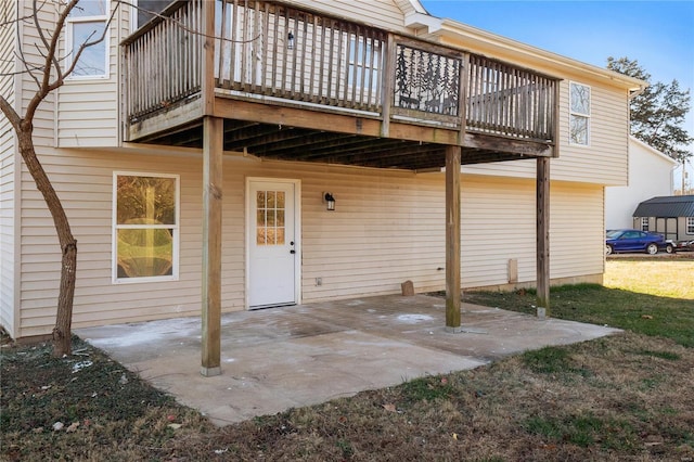 exterior space with a patio, a lawn, and a wooden deck