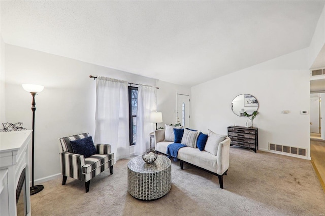 living room with light carpet and a textured ceiling