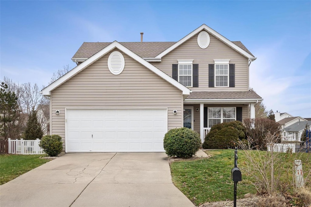 front facade featuring a garage and a front lawn