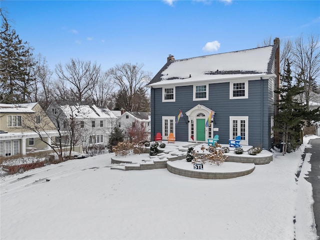 colonial-style house featuring a chimney