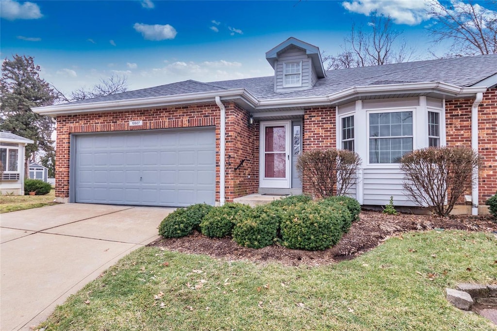 ranch-style house with a garage and a front lawn