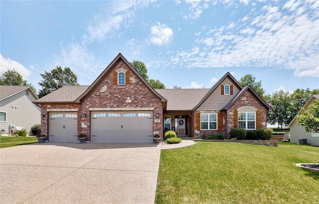 view of front of house featuring cooling unit, a garage, and a front lawn