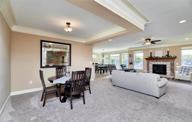 carpeted dining area featuring plenty of natural light, ornamental molding, and ceiling fan